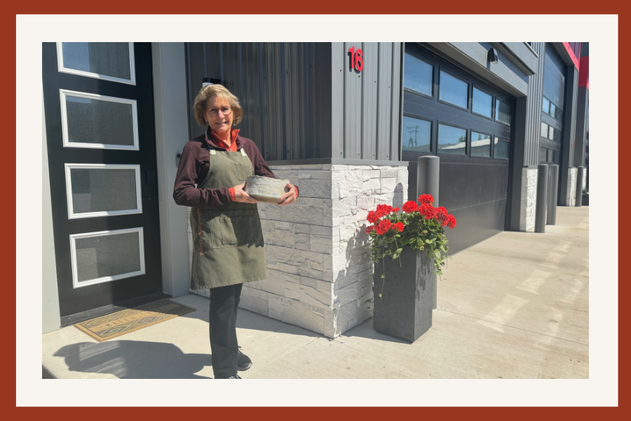 cyndi holding handmade bowl outside new studio