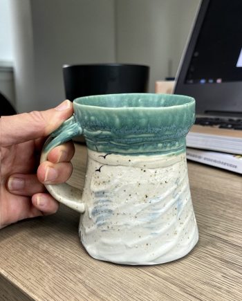 Shoreline light II ceramic mug with beach sand