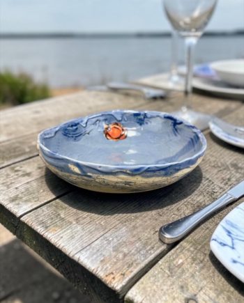Lake Michigan ceramic bowl with blue glaze interior and sunset detail
