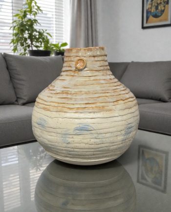 hand coiled porcelain demijohn vase with lake michigan sand glaze on a living room table