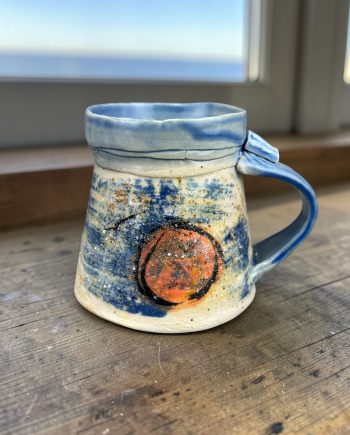 handmade Lake Michigan ceramic mug with wave texture, beach sand glaze, and blue interior