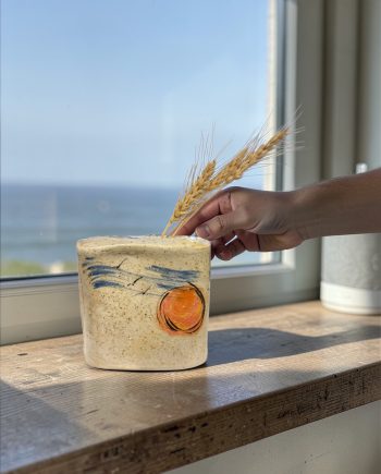 Sun over Lake Michigan ceramic flower brick vase by a window