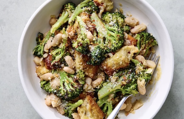 brocolli and white bean caesar salad in a serving bowl