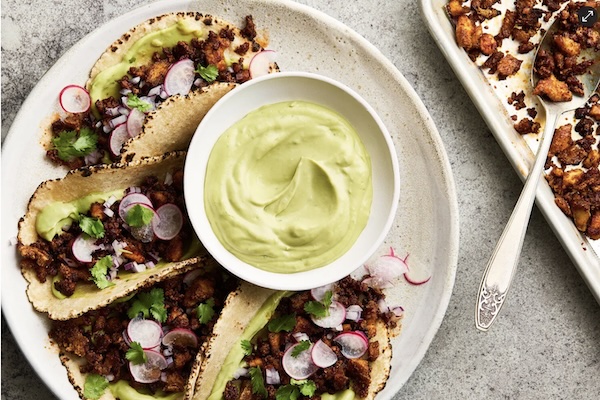 A plate of crispy tofu tacos with dipping sauce
